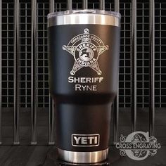 a black and silver tumbler with the words sheriff ryane on it