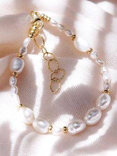 Beautified with an assemblage of lustrous white freshwater pearl beads, this 18k gold filled pearl bracelet alludes to the soothing sands of Hawaii's shores. Wear this gold pearl bracelet alone or stacked for a classically elegant look. ✦ DETAILS ✦✧ Name: Hiwahiwa (HEEvah HEEvah) - precious, beloved, indulged. ✧ Adjustable Length from: 7"-8.5".✧ White Freshwater Pearls.✧ 14kt Gold Filled Components, Extender, and Clasp.✧ All Ke Aloha Jewelry pieces come packaged thoughtfully, beautifully, and re Luxury Dainty Oyster Bracelet, Pearl Bead Bracelet, Black Pearl Bracelet, Gold Pearl Bracelet, Peacock Pearl, White Pearl Bracelet, Freshwater Pearl Bracelet, Pearl Collection, White Freshwater Pearl