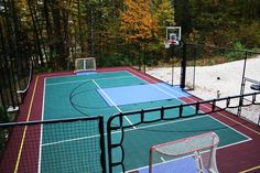 an outdoor basketball court surrounded by trees