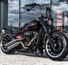 a black and red motorcycle parked in front of a building