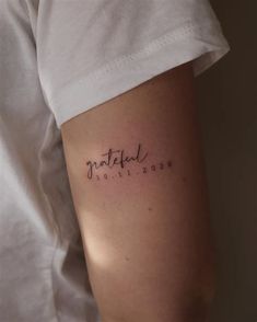 a woman's arm with the word tattoo on it