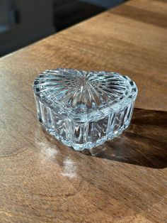 a glass box sitting on top of a wooden table