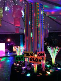 a party tent with lights and decorations on the floor, including streamers that say'your on get glow '