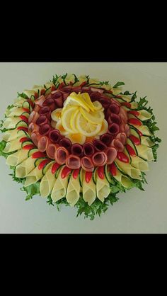 an arrangement of vegetables and fruit arranged in the shape of a circle