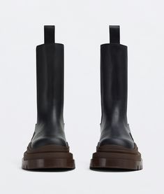 "Find BOTTEGA VENETA Tire Chelsea Boot on Editorialist. Vegetally-tanned leather Chelsea boots. Lining: Calfskin. Color: Black/Ebony. Rubber outsole. Flatform: 5.5 cm | 2.2\". We recommend to take half a size down. • Material: Calfskin." Black Calf Leather Platform Boots With Rubber Sole, Black High Ankle Chelsea Boots In Calf Leather, Black Calf Leather Platform Boots, Black Calf Leather Platform Boots With Leather Lining, Designer Black Leather Chelsea Boots, Black Leather Platform Boots With Leather Sole, Designer Black Chelsea Boots For Fall, Black Calf Leather Heeled Boots With Rubber Sole, Black Calf Leather Boots With Leather Footbed