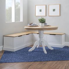 a table with two benches on top of it and a potted plant in the corner