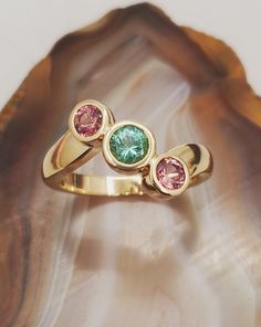 DEN2402 Maine tourmaline ring. Three stone 14k yellow gold ring with bezel set Maine pink and green tourmaline.  Gemstones are from the Dunton quarry in Newry, Maine. Tourmaline total weight is approximately 1ct. Durable, low profile ring designed by Dennis Creaser. Current size is 8.25, we will resize at no extra charge, please specify ring size at checkout if resizing is needed. Newry Maine, Ring Three Stone, Retail Jewelry, Colored Stone Rings, Three Stone Ring, Tourmaline Jewelry, Cabochon Ring, Tourmaline Ring, Custom Jewelry Design