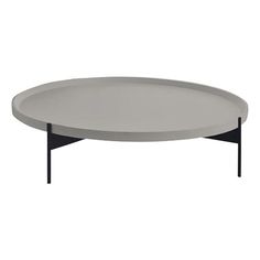 an oval table with black legs and a white surface on the bottom, in front of a