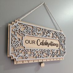 a wooden sign hanging from the side of a wall with an inscription on it that reads our celebration