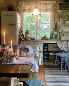 a kitchen filled with lots of furniture next to a window