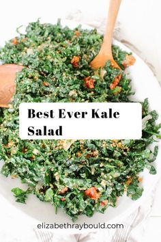 the best ever kale salad recipe is in a white bowl with wooden spoons