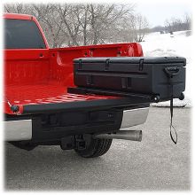 the back end of a pickup truck with luggage strapped to it