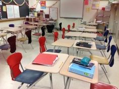 an empty classroom filled with desks and chairs