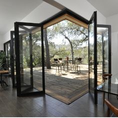 an open room with glass doors and tables