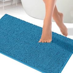 a person walking across a bathroom rug on the floor