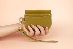 small olive green leather card wallet wristlet with pocket and goldware Versatile Coin Purse With Card Slots For Gift, Versatile Wristlet With Card Slots For Daily Use, Versatile Coin Purse With Interior Card Slots For Gift, Versatile Coin Purse With Card Slots As Gift, Versatile Daily-use Wristlet With Card Slots, Trendy Everyday Clutch With Interior Card Slots, Trendy Wristlet With Card Slots For Everyday Use, Leather Wristlet With Zipper Pouch For Daily Use, Trendy Leather Coin Purse Gift