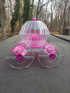 a pink and clear carriage with flowers on it