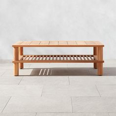 a wooden bench sitting on top of a tile floor