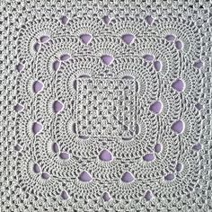 a crocheted doily with purple hearts on it