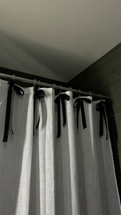 black and white curtains hanging on the side of a wall