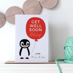 a card with a penguin holding a red balloon