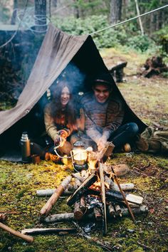 a person sitting in front of a tent with the words you me camping