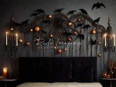 a bed with candles and pumpkins on the headboard