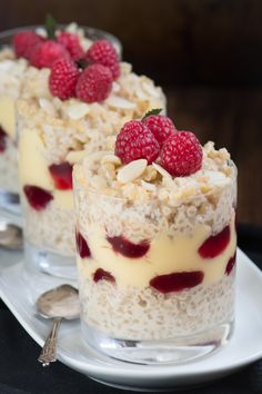 two desserts with raspberries and oatmeal are on a plate