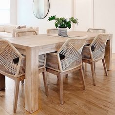 a dining room table with chairs and a potted plant on the top of it