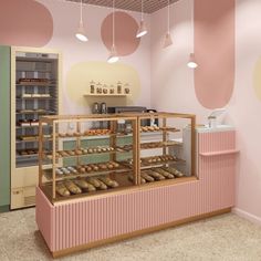 a bakery filled with lots of donuts on top of pink counter tops next to a green door