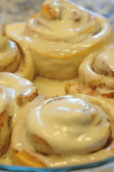 cinnamon rolls with icing in a glass dish