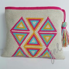 a white and pink bag with tassels on it