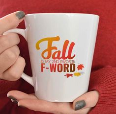 a woman holding a coffee mug with fall is my and favorite f word on it