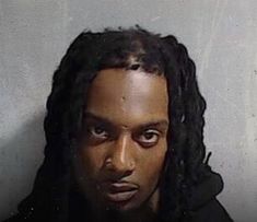 a man with dreadlocks is shown in this undrecognized mug shot