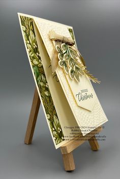 an easel holding a card with a bow on it