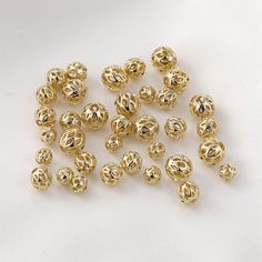 gold plated beads on white background