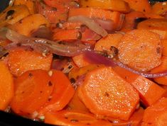 carrots and onions cooking in a black pan