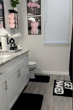 a bathroom with black and white rugs on the floor