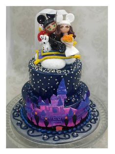 a wedding cake with mickey and minnie on top is decorated in blue, purple and white