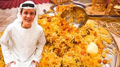 a man standing in front of a pile of food