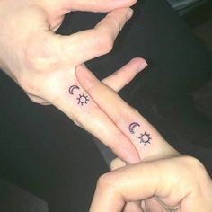 two people with matching tattoos on their fingers