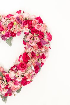 a heart made out of flowers on a white background