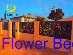 a fence that has flowers on it and the words flower bed written in front of it