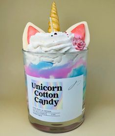 unicorn cotton candy in a glass jar with an unicorn horn on top