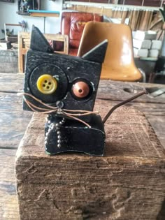 a black cat sitting on top of a wooden table