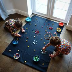 two children playing with toys on the floor