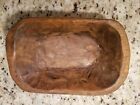 a wooden bowl sitting on top of a counter