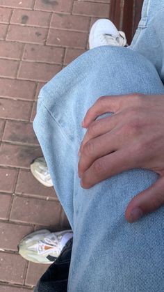 a person with their hand on his knee