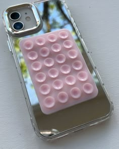 a cell phone case with pink bubbles in the shape of an object on it's back cover