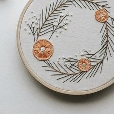 a close up of a embroidery on a white surface